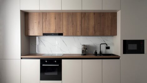 A modern built-in kitchen with appliances in a minimalist style.